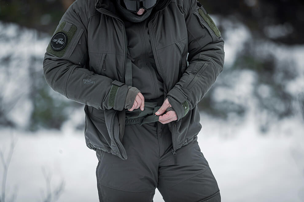 Tactical operator walking through a snowy clearing