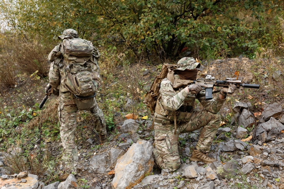 Soldiers in MultiCam camouflage combat pants and knee pads.