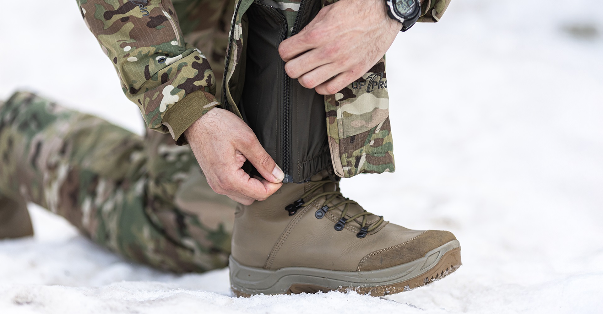 Close-up of an operator's ankle showcasing waterproof gaiters with a zipper.