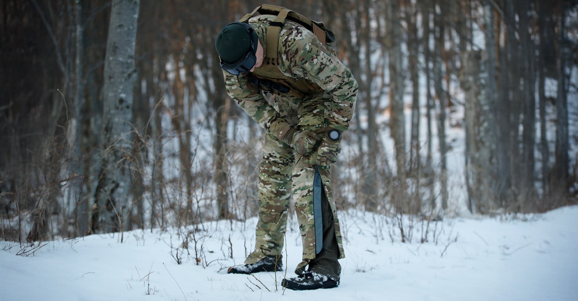 Operator zipping up the side of his tactical pants with a windstopper inner liner in place.