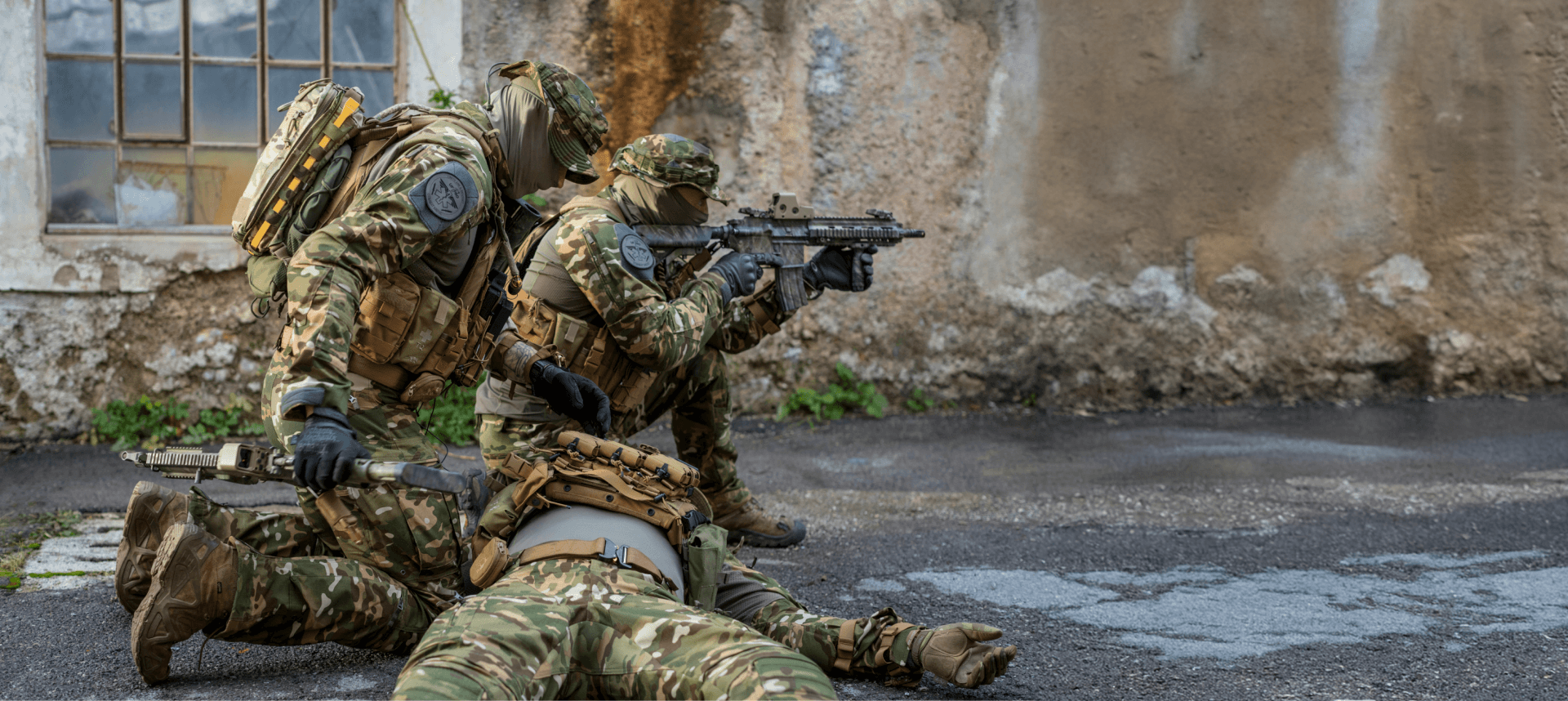 A soldier is being examined after collapsing on the ground. 