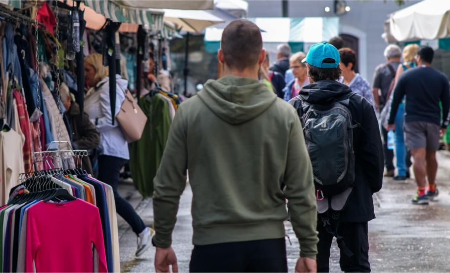 Individual walking confidently in an urban setting while observing his environment, demonstrating situational awareness.