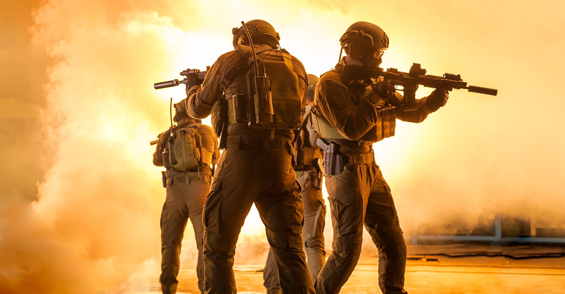 Operators standing back-to-back as a large explosion ignites behind them, engulfing the scene in flames.