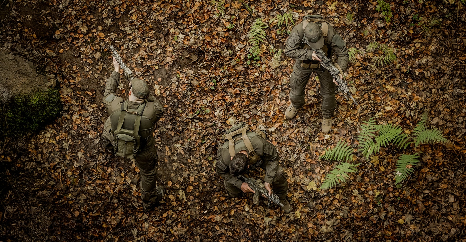 Three operators observed from above, securing the perimeter and scouting for valuable information.