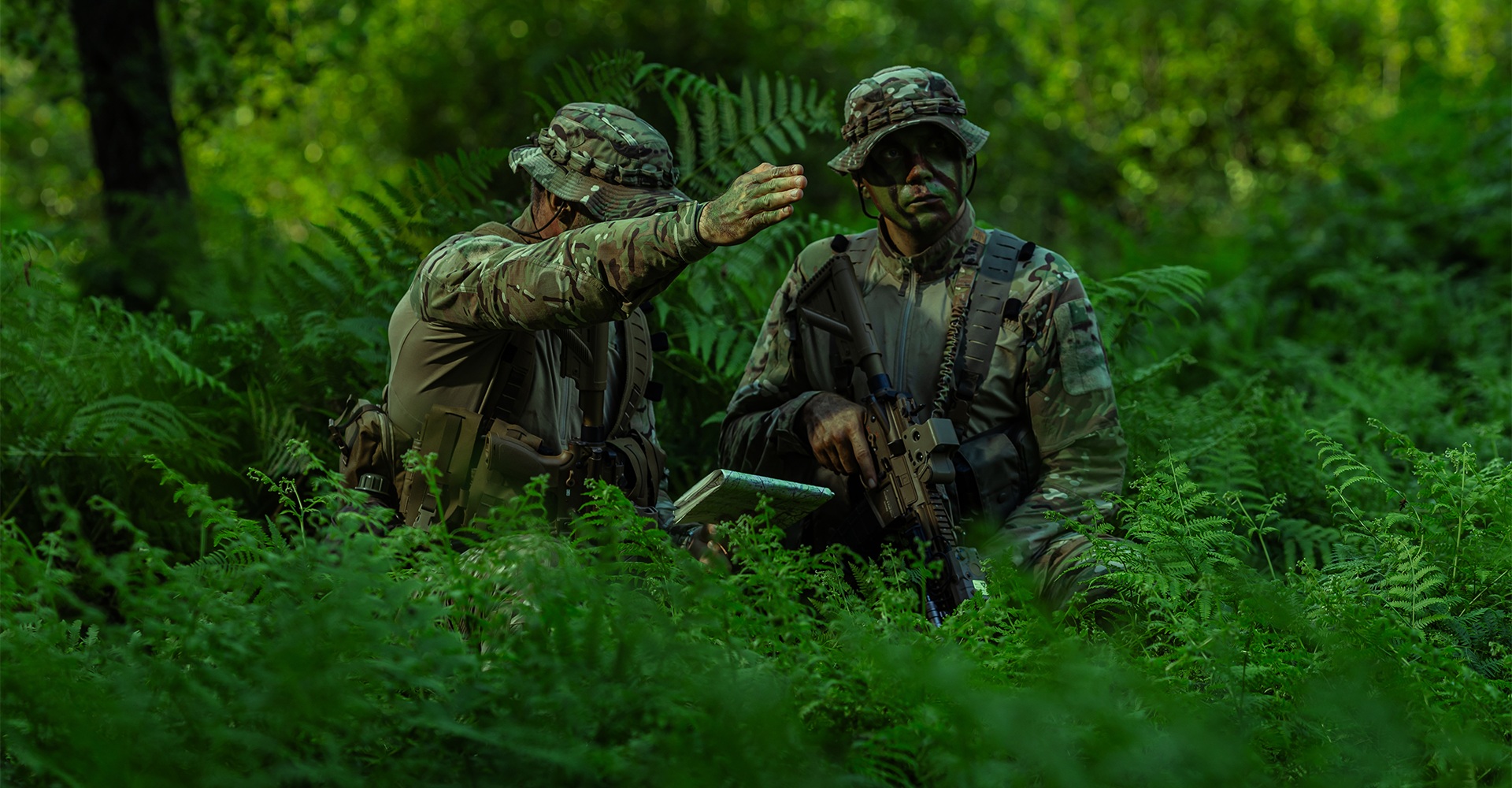 Two operators pausing their mission to study the map and determine the next course of action.