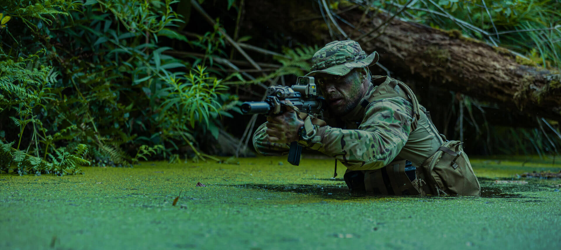 Silhouette of a soldier in tropical forest light, capturing the intensity and focus required in jungle operations.