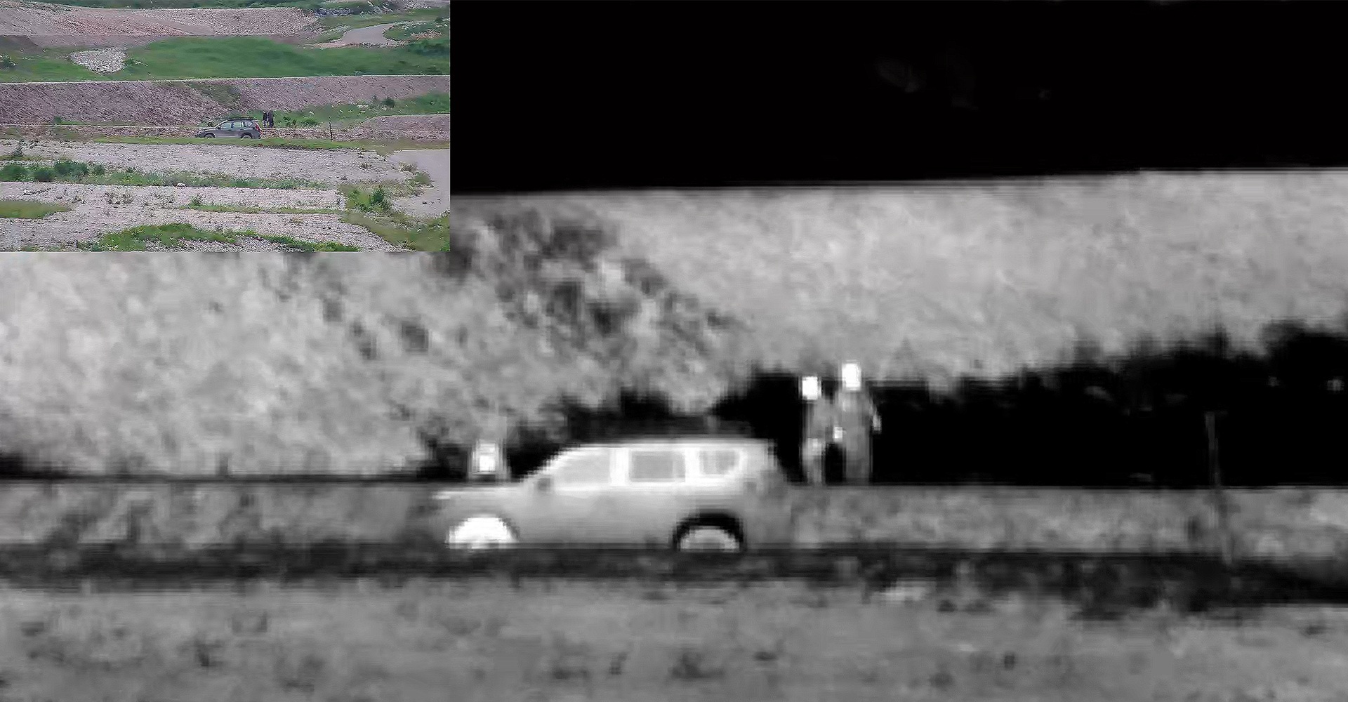 Two people standing beside a vehicle spotted on a thermal camera. 