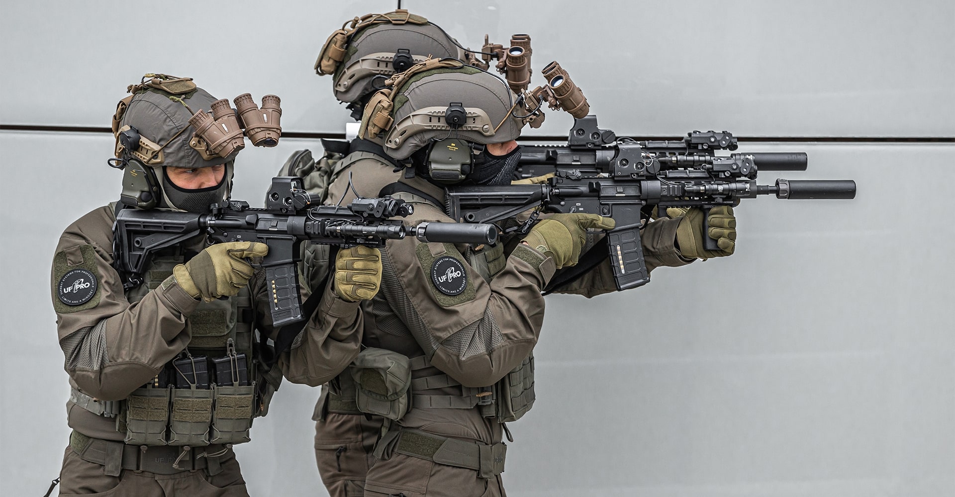 Special forces operators on a mission, fully equipped in combat gear and aiming their firearms.