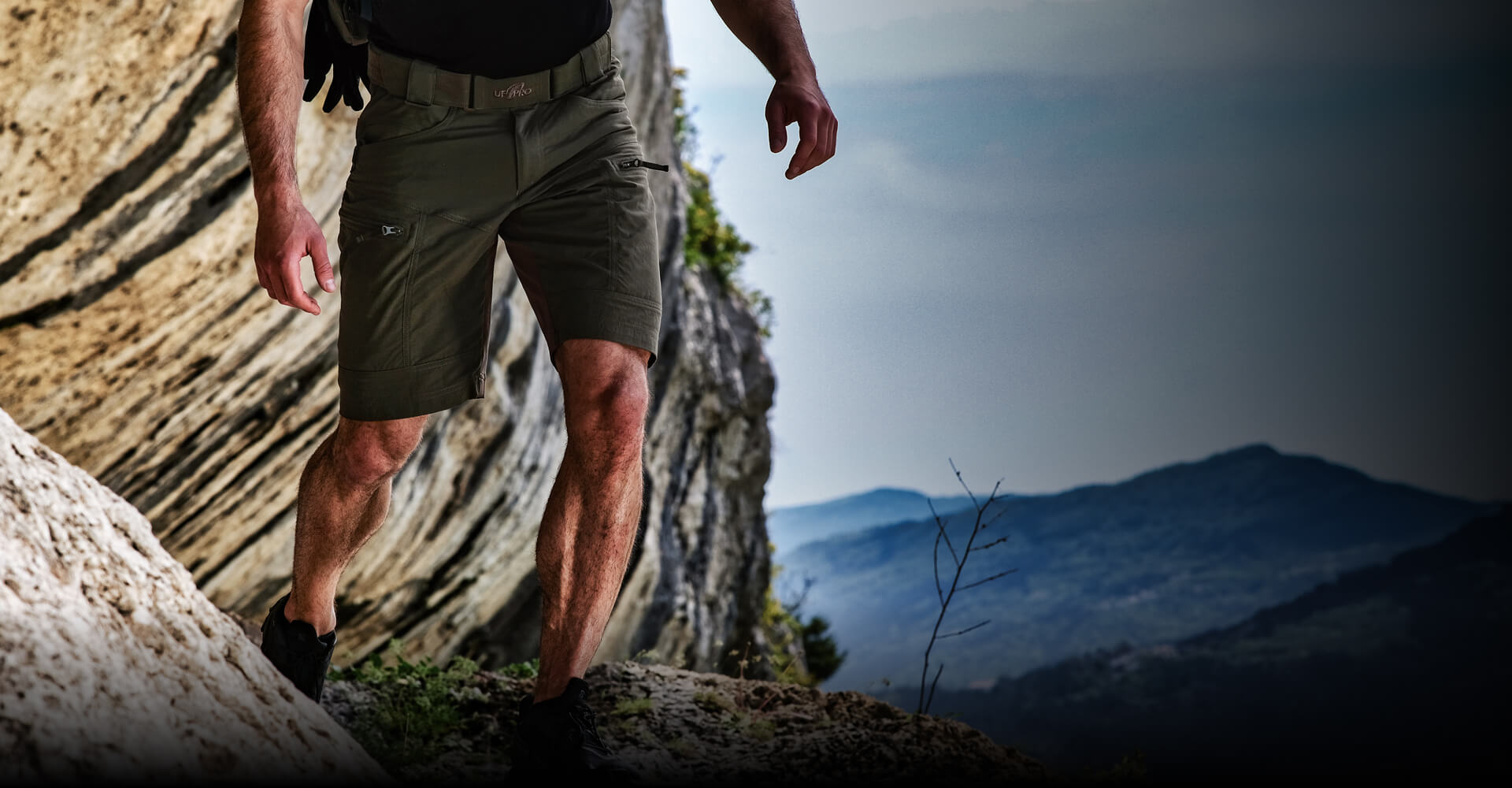 Person in P-40 Ranger Shorts on rocky terrain.