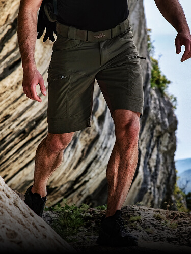 Person in P-40 Ranger Shorts on rocky terrain.