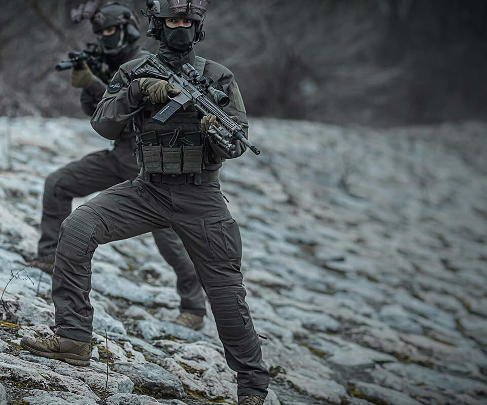 Two tactical operators standing on the river bank wearing Striker XT Gen.3 BDU.