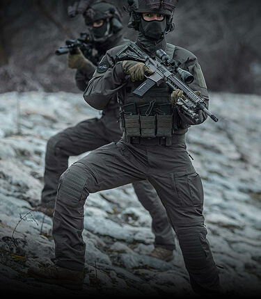 Two tactical operators standing on the river bank wearing Striker XT Gen.3 BDU.